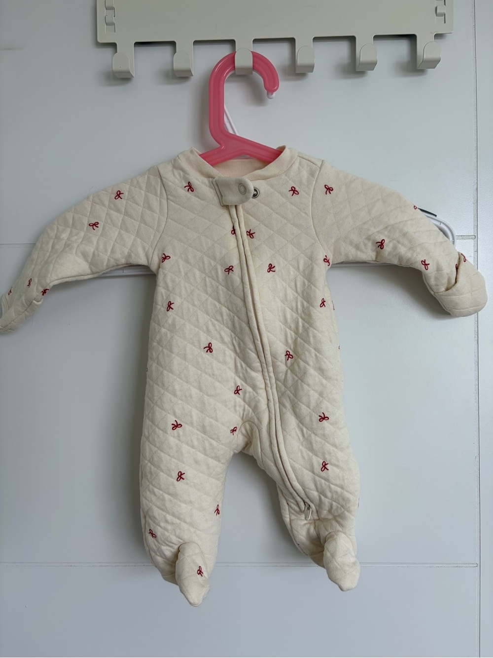Cream Quilted Footed One-Piece with Red Bow Detail